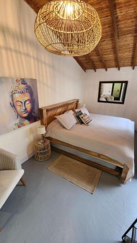 a bedroom with a large bed and a chandelier at Vintage House With Jacuzzi In Manila in Medellín