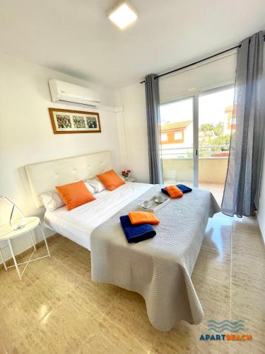 a bedroom with two beds and a large window at APARTBEACH GREEN RELAX MUY LUMINOSO JUNTO PLAYA y BARBACOA in Salou
