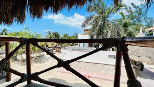 a view of a temple from a wooden fence at Hotel MAYARI Holbox in Holbox Island