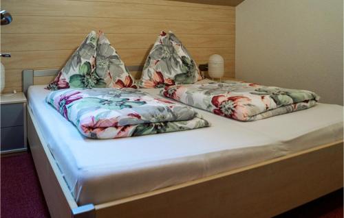 a bed with two pillows on top of it at Cozy Apartment In Reith Im Alpbachtal With Wifi in Reith im Alpbachtal