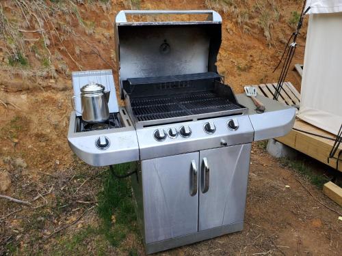 a gas grill with a kettle on top of it at Tentrr Signature Site - Greener Acres Roan Mountain View in Roan Mountain