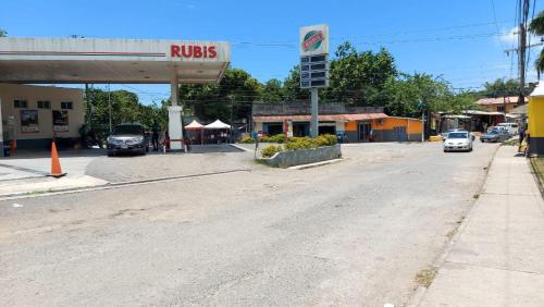 an empty street in a town with a rukes gas station at Lovely 2 Bedroom House in St Thomas Jamaica in Belfast