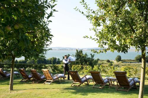 a woman taking a picture of a row of chairs at La Ferme Saint Simeon Spa - Relais & Chateaux in Honfleur