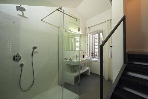 a glass shower in a bathroom with a sink at La Porta Luxury Rooms in Split