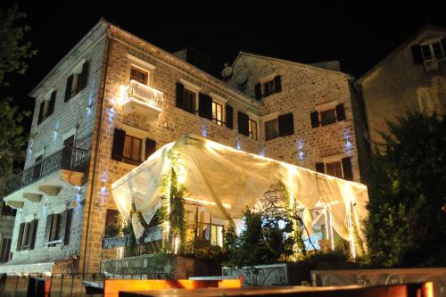 a building with a tent in front of it at night at Hotel Villa Duomo in Kotor