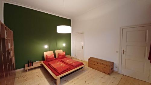 a bedroom with a bed with a green wall at Designerwohnung Berlin Mitte in Berlin