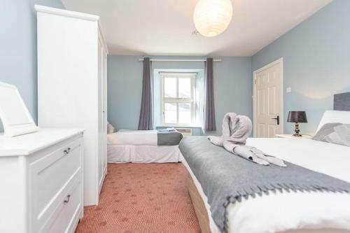 a bedroom with two beds and a window at Clonbur House - One bedroom apartment in Galway