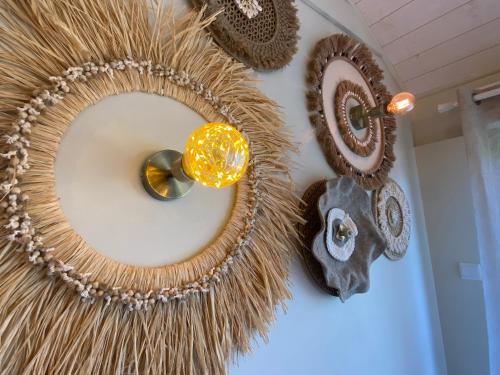 a wreath hanging on a wall with other decorations at Entre Honfleur et Etretat in Octeville-sur-Mer