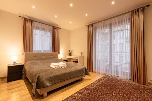 a bedroom with a bed and a large window at Basha Apartment PREMIUM Sopot 2 in Sopot