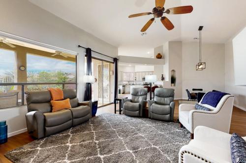 a living room with couches and a ceiling fan at Starmist Mountain View in Oro Valley