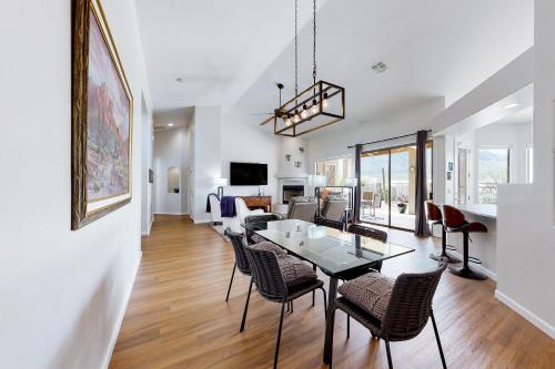 a dining room and living room with a table and chairs at Starmist Mountain View in Oro Valley
