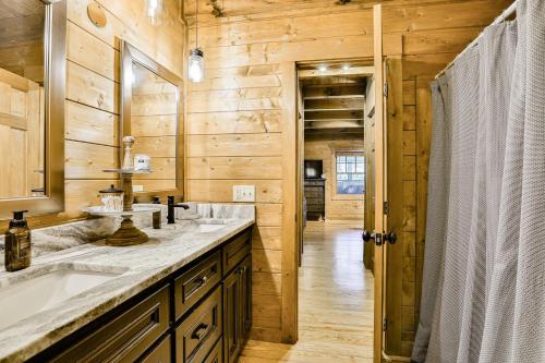 a bathroom with two sinks and a mirror at Ivylog Creek Getaway in Young Harris