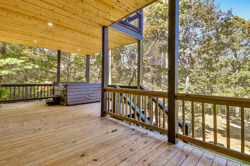 an empty porch of a wooden house with windows at Ivylog Creek Getaway - STR License #00,7980 in Young Harris