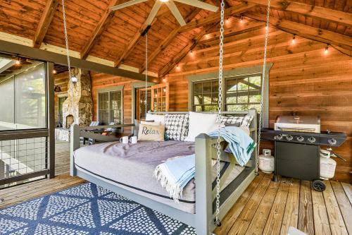 a bedroom in a log cabin with a bed and a desk at Ivylog Creek Getaway in Young Harris