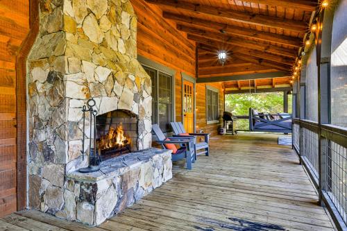 a large stone fireplace on a porch of a house at Ivylog Creek Getaway - STR License #00,7980 in Young Harris