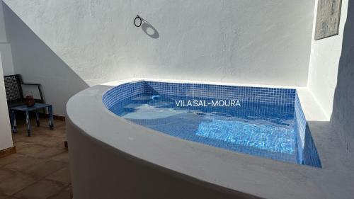 a swimming pool in the middle of a room with a blue tiled at Vila Sal-Moura in Moura