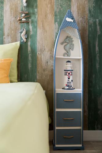 a bedroom with a bed and a shelf with a mirror at HC Torreira Beach in Torreira