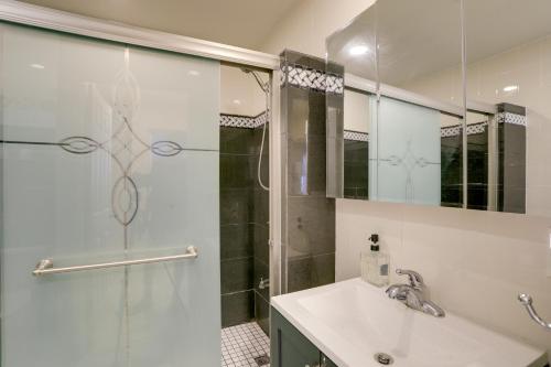 a bathroom with a glass shower and a sink at Waterfront Home with Game Room, 2 Miles to Beach! in Seminole