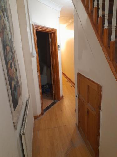 a hallway with a staircase and a wooden door at Zoom in Portsmouth