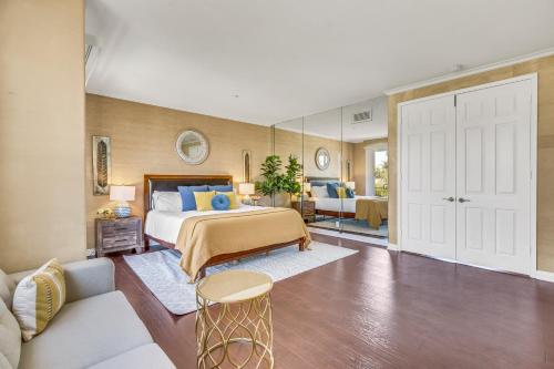 a bedroom with a bed and a living room at A Stunning Beach villa Walking to Huntington Beach in Huntington Beach