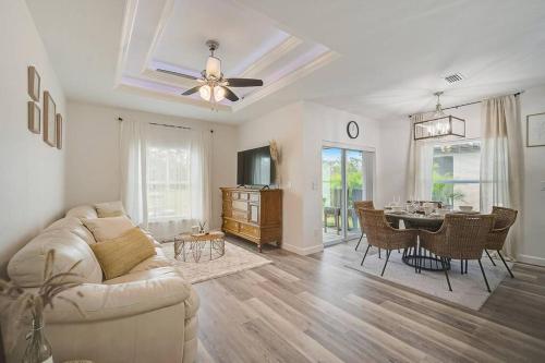 a living room with a couch and a dining room at Sunny Coastal,3 BD, 2 BA, King Master Suite, Close to Ocean, Golfing , Fishing in Rotunda-West