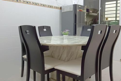 een eettafel met vier stoelen eromheen bij PD 9Pax x 3BR Single Storey House in Port Dickson