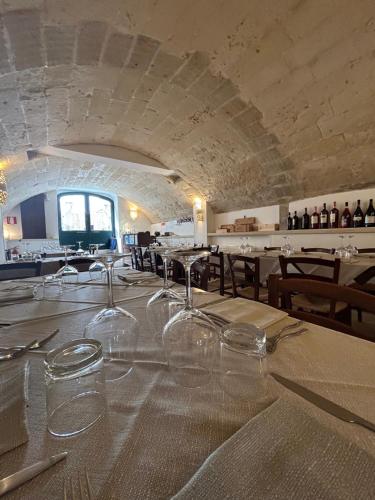 a dining room with wine glasses on a table at Balconcino d'Oriente in Otranto