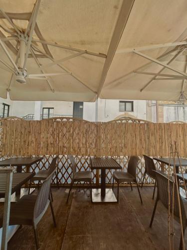 a tent with tables and chairs in a room at Balconcino d'Oriente in Otranto
