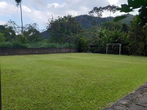a large grassy yard with a soccer goal at Sítio dos Guedes in Guapimirim