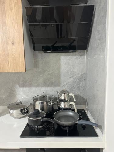a stove with pots and pans on top of it at 2 bedroom in an sexy compound with Balcony in Antalya