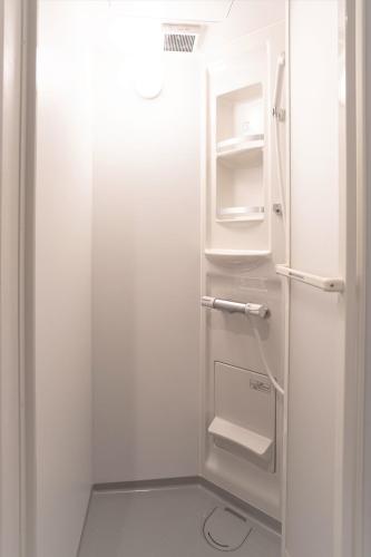 a white refrigerator with its door open in a kitchen at 東京日和 in Tokyo