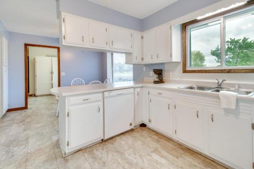 a kitchen with white cabinets and a sink and a window at Gassville Home 3 Mi to White River and Trout Fishing in Gassville