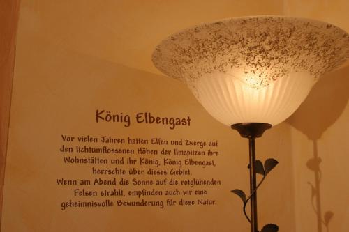 a sign on the wall of a room with a lamp at Alfaierhof-Bergheimat in Gschnitz