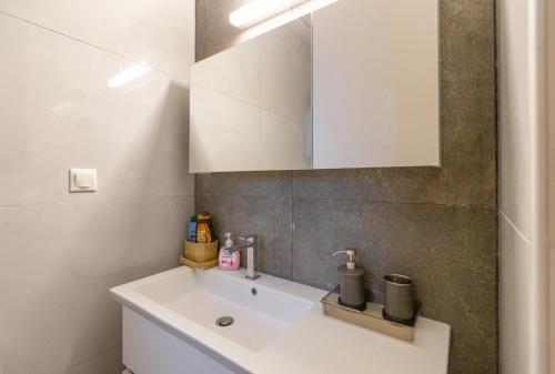 a bathroom with a white sink and a mirror at La Villa del Mare - Nafpaktos Beach in Nafpaktos