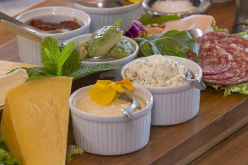a tray of different types of cheese and other foods at Whalesong Lodge in Gansbaai