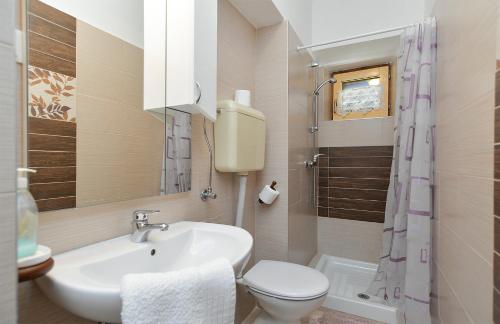 ein Bad mit einem Waschbecken und einem WC in der Unterkunft Apartments with a parking space Kukci, Porec - 20797 in Poreč