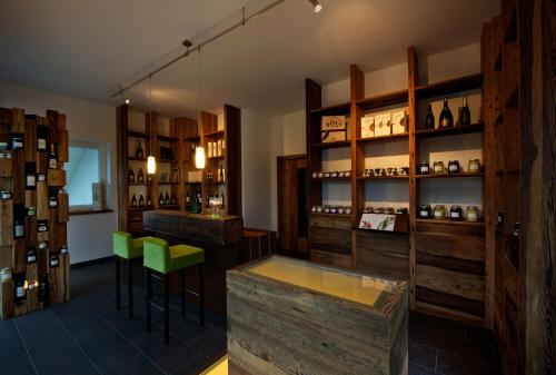 a wine tasting room with wooden cabinets and green stools at Agriturismo Florandonole in Fai della Paganella