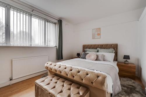 a bedroom with a large bed and a large window at Alford house in Manchester