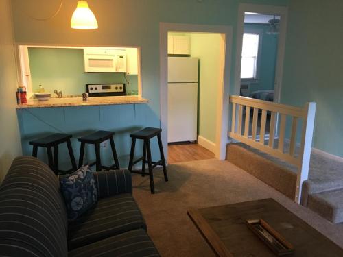 a living room with a couch and a kitchen at Cozy Bay View OceanSide cottage in Willoughby Beach
