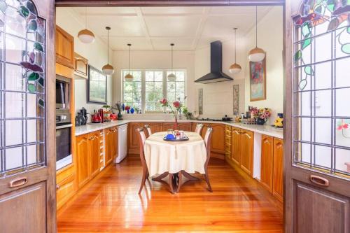 a kitchen with a table with a white table cloth at History @ Renall in Masterton