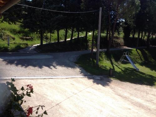 a road with a playground with a swing at Agriturismo Longetti in Assisi