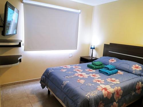 Una cama o camas en una habitación de Calido departamento en Ushuaia 7