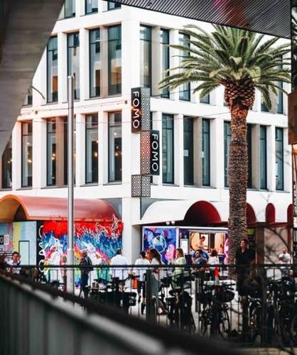 a palm tree on a city street with a building at Little Lane Apartments Comfortable, Chic New Apartment in Heart Of Fremantle Features Large balcony & Free car bay in Fremantle