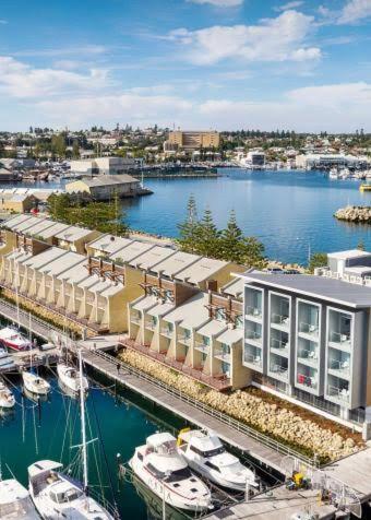 an aerial view of a marina with boats in the water at Little Lane Apartments Comfortable, Chic New Apartment in Heart Of Fremantle Features Large balcony & Free car bay in Fremantle