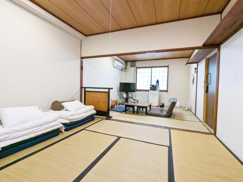 a living room with two couches and a table at Tabist Hamanako no Yado Kosai in Kosai