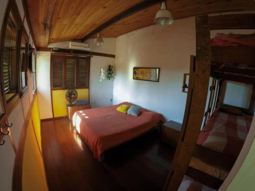 a bedroom with a bed and a staircase in it at Casa grande,3 min a pé do Centro, grupos, familias in Paraty