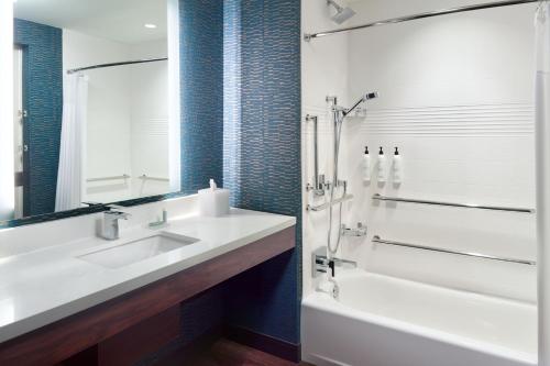 a bathroom with a sink and a tub and a shower at TownePlace Suites Nashville Downtown/Capitol District in Nashville