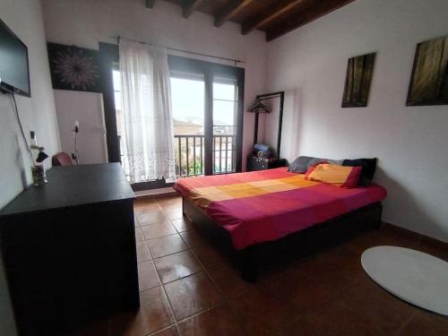 a bedroom with a bed and a large window at LANZATE! in Tinajo