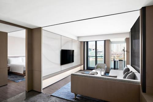 a hotel room with a television and a living room at JW Marriott Shanghai Fengxian in Shanghai
