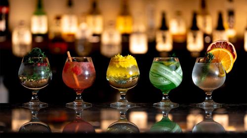a group of wine glasses sitting on a counter with wine bottles at TUNE STAY KYOTO in Kyoto
